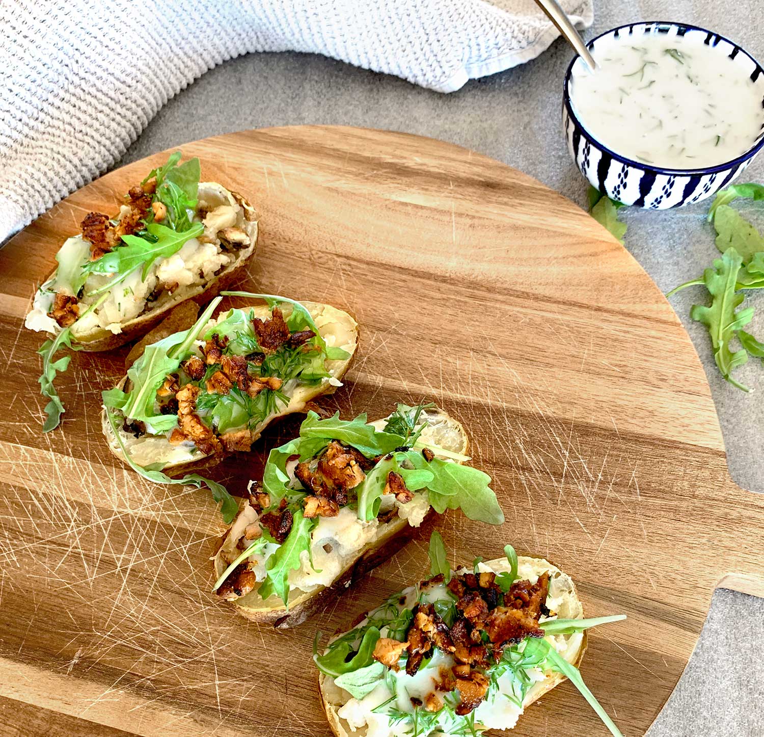 Baked potato with lion's main "bacon" and coconut dill sour cream