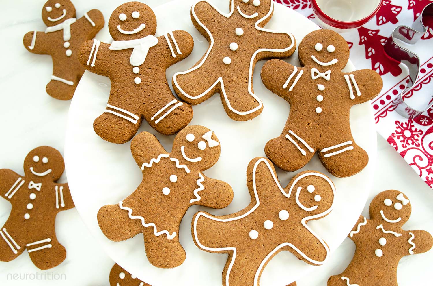 Gingerbread people-shaped cookies, with white icing decorations.